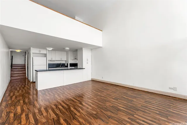 a view of kitchen with stainless steel appliances cabinets and wooden floor