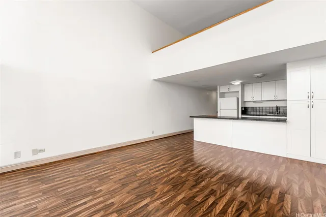 a view of kitchen with refrigerator and a stove