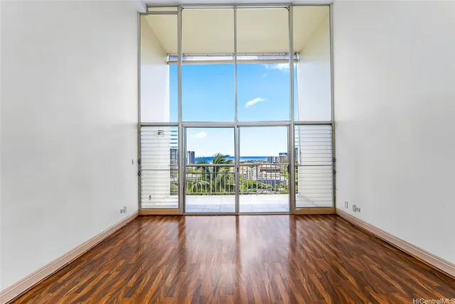 a view of empty room with wooden floor