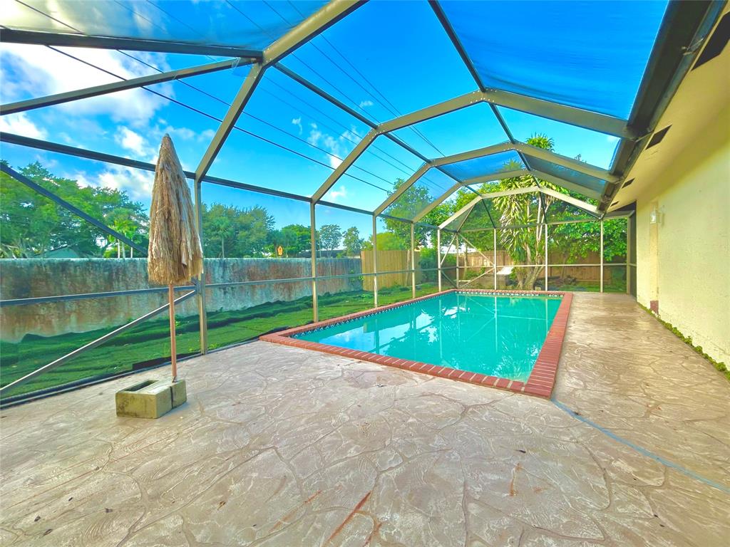 8948 Southwest 18th Road Boca Raton, FL 33433 - Photo 11 of 24 a view of a backyard with swimming pool