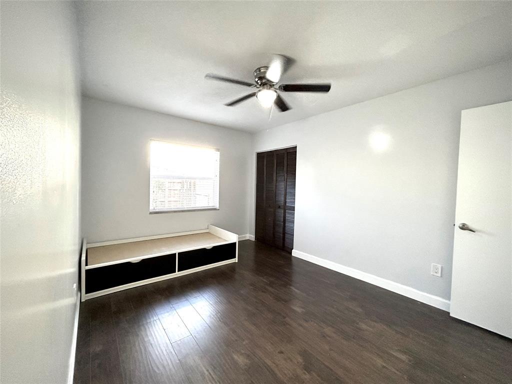 8948 Southwest 18th Road Boca Raton, FL 33433 - Photo 17 of 24 an empty room with wooden floor fan and windows