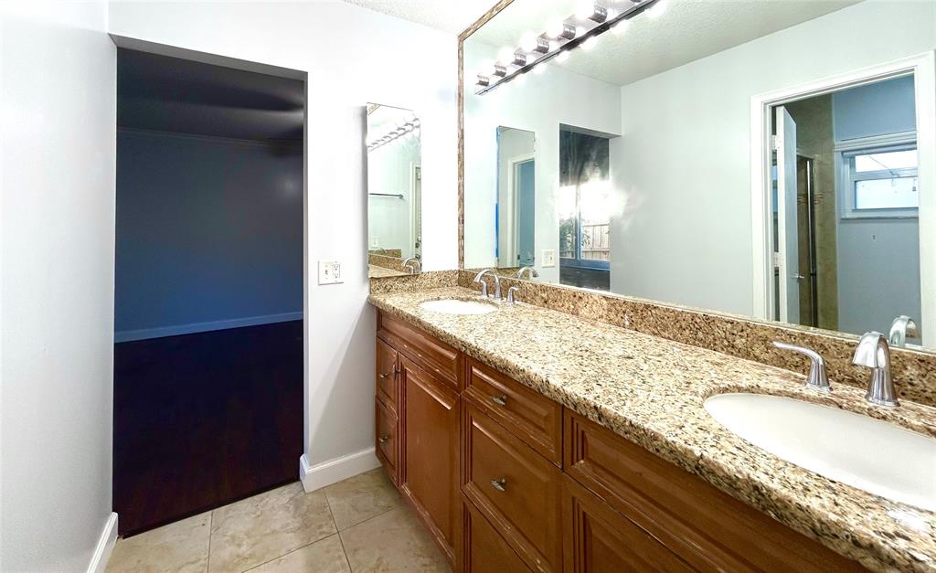 8948 Southwest 18th Road Boca Raton, FL 33433 - Photo 21 of 24 a bathroom with a granite countertop sink and a mirror