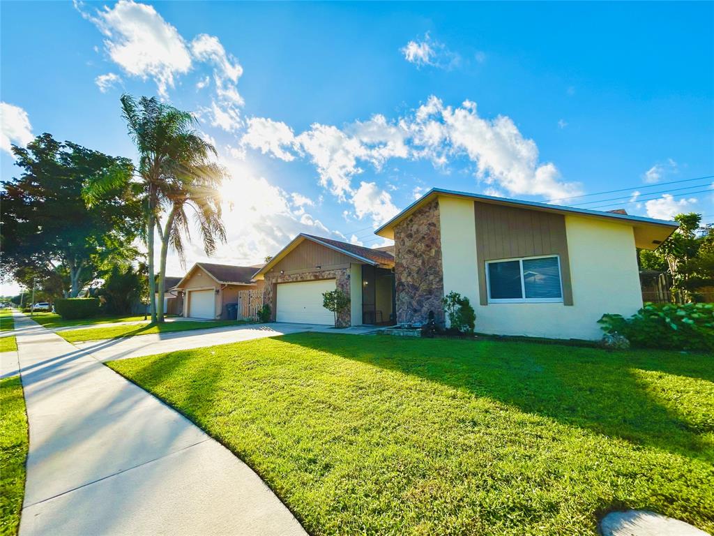 8948 Southwest 18th Road Boca Raton, FL 33433 - Photo 3 of 24 a view of a house with a yard