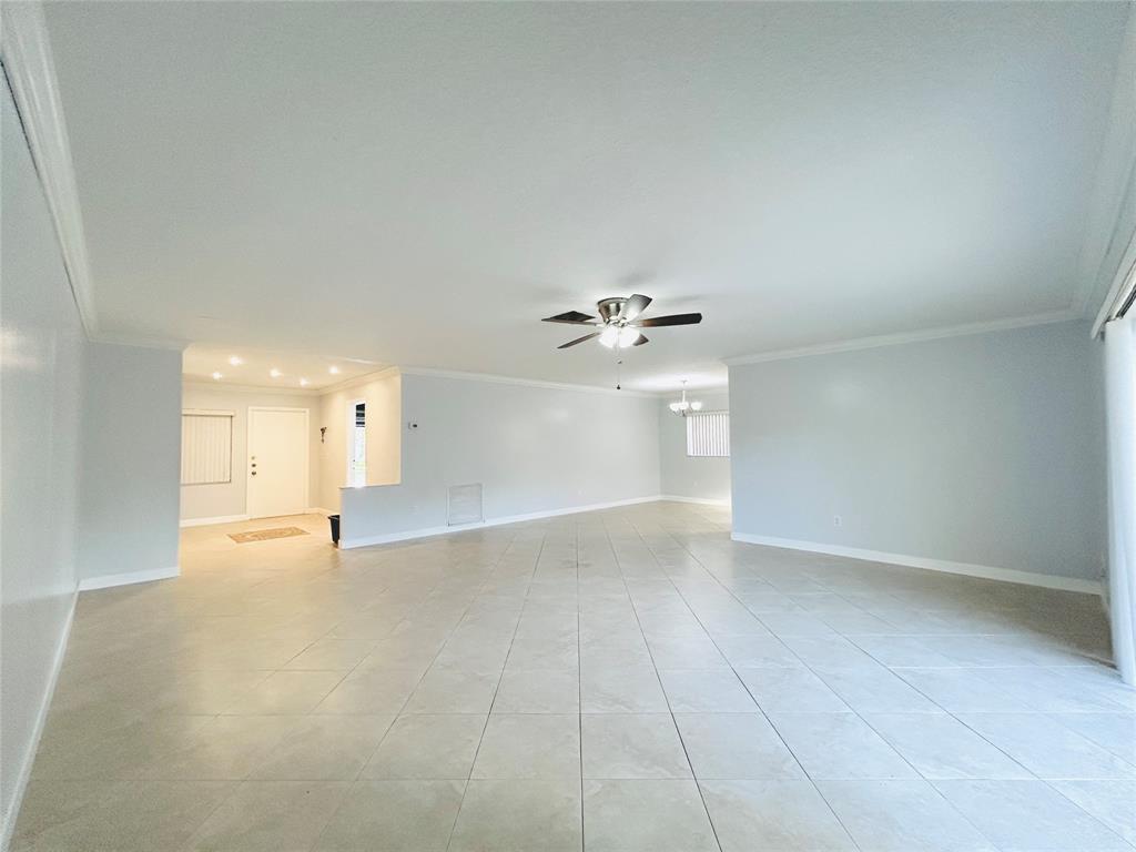 8948 Southwest 18th Road Boca Raton, FL 33433 - Photo 5 of 24 an empty room with a empty space and a ceiling fan