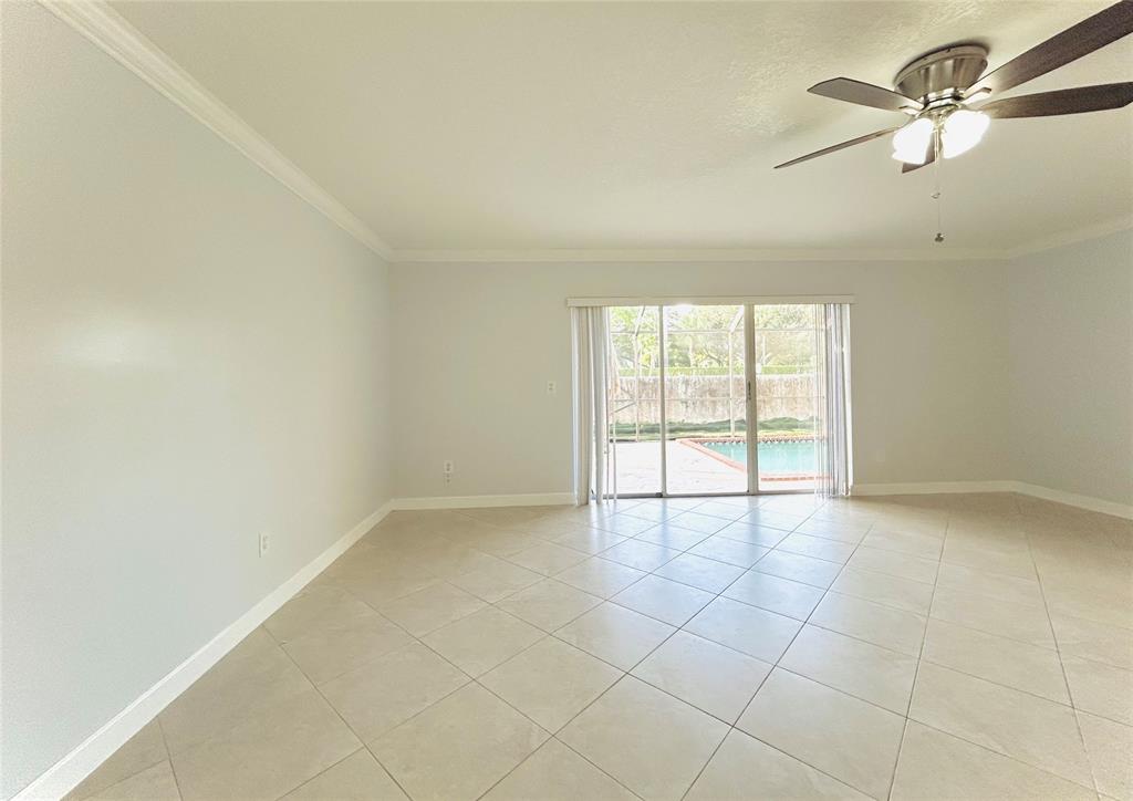 8948 Southwest 18th Road Boca Raton, FL 33433 - Photo 8 of 24 an empty room with windows and fan