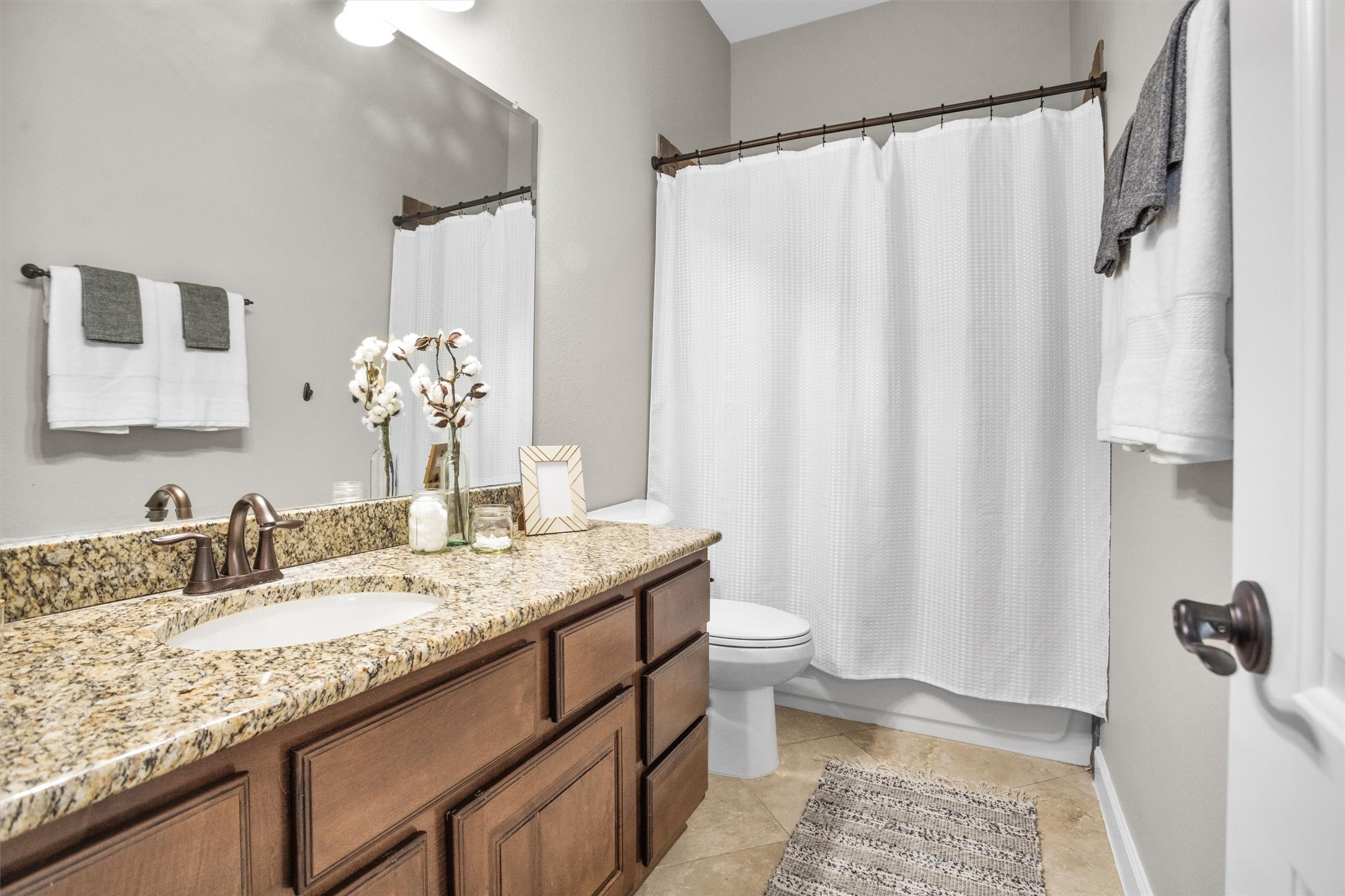 27910 Hansons Court Spring, TX 77386 - Photo 22 of 50 Hollywood bath with granite, oil rubbed bronze fixtures, Kentmore cabinetry, undermount sink and is located in the hallway adjacent to the second and third bedrooms.