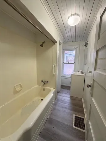 a bathroom with a bathtub and a shower