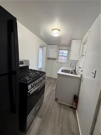 a kitchen with a stove and a refrigerator