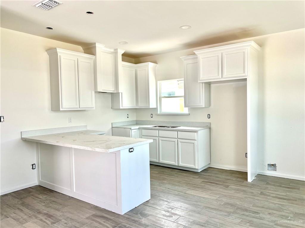 1821 Monaco Drive, Unit 2 San Juan, TX 78589 - Photo 14 of 16 a kitchen with a sink cabinets stainless steel appliances and a window