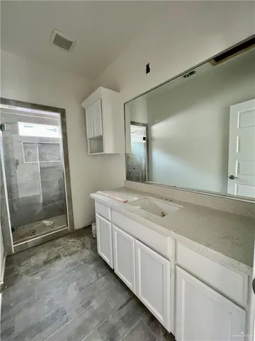 a view of a kitchen with wooden floor and a sink