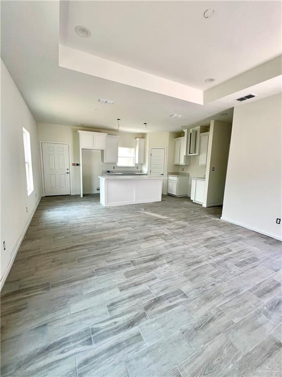1821 Monaco Drive, Unit 2 San Juan, TX 78589 - Photo 10 of 16 a view of a kitchen with wooden floor and a sink