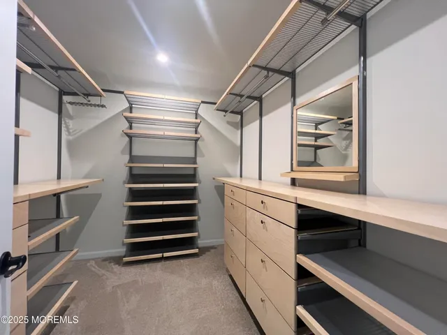 a spacious bathroom with a toilet sink and mirror