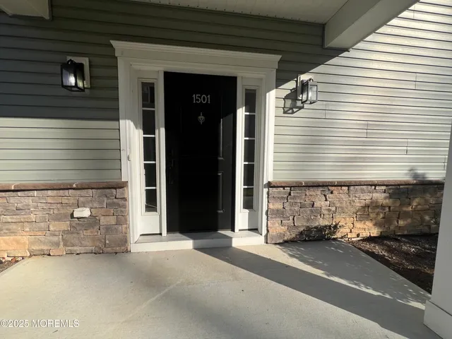 a view of a house with a door and a car parked