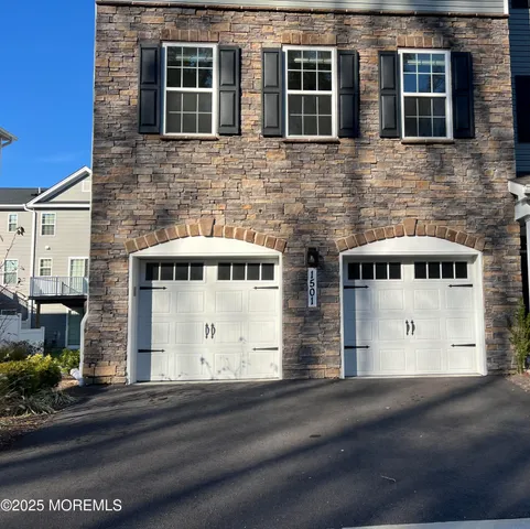 a front view of a house with a road