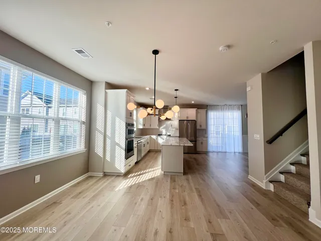 a view of a living room and a wooden floor
