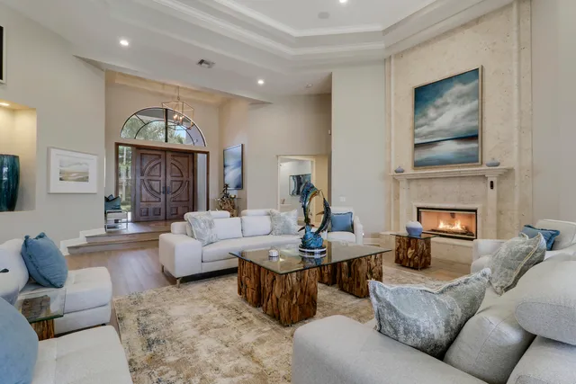 a living room with furniture and a view of kitchen