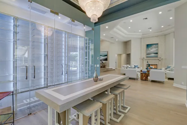 a dining room with furniture a chandelier and fireplace