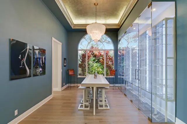 a view of a hallway with wooden floor and windows