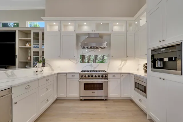 a kitchen with a stove a microwave and wooden floor