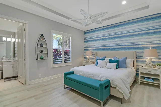 an aerial view of a city with lots of residential buildings ocean and mountain view in back