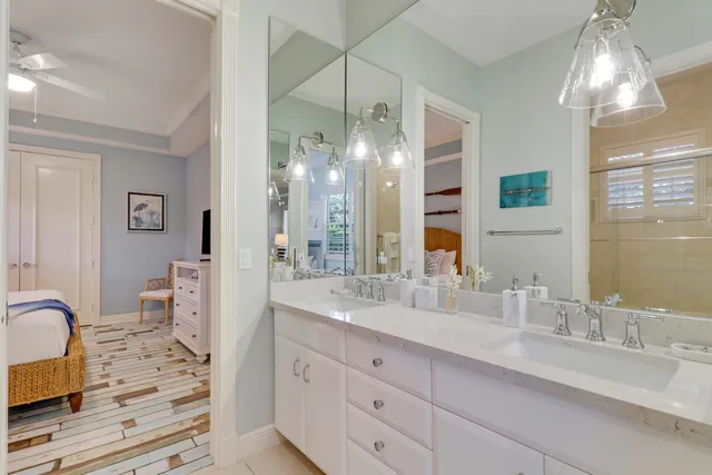 a view of a swimming pool with a lawn chair and palm trees