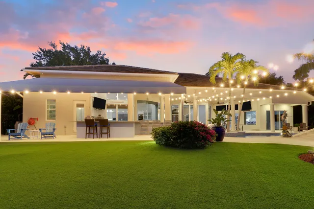 a living room with furniture a rug and white walls