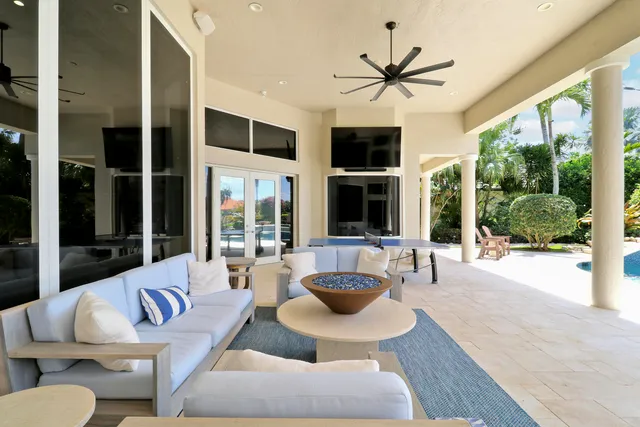 a living room with furniture fireplace and a large window