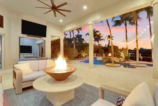 a living room with furniture fireplace and a large window