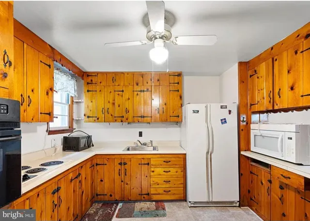 a kitchen with stainless steel appliances a refrigerator and a stove top oven