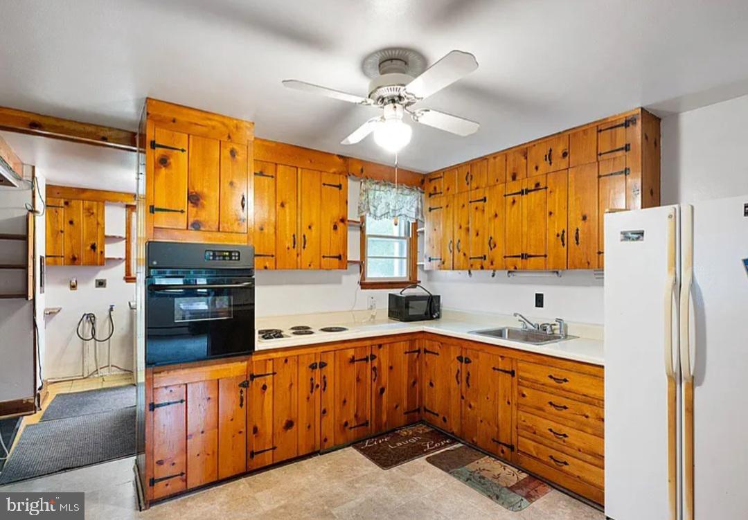 2445 Kenton Road Dover, DE 19904 - Photo 12 of 20 a kitchen with stainless steel appliances a refrigerator sink and cabinets