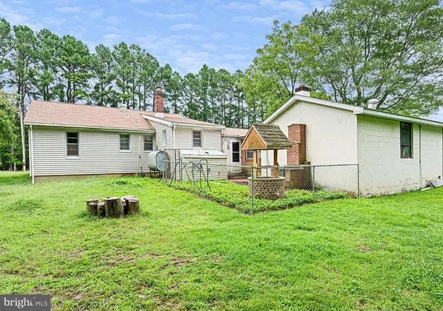 a view of a house with a yard and a garden