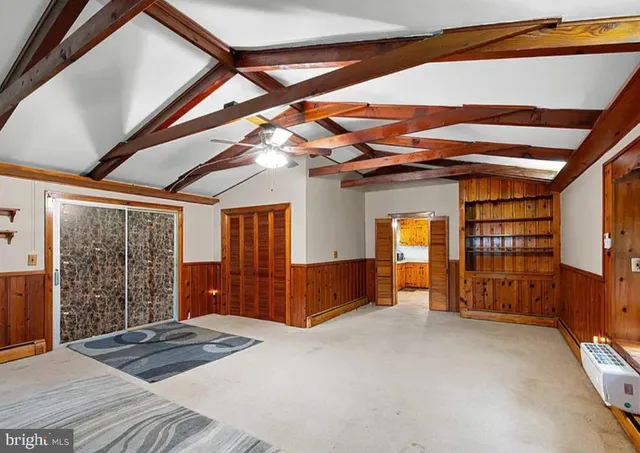 a view of a livingroom with furniture and staircase