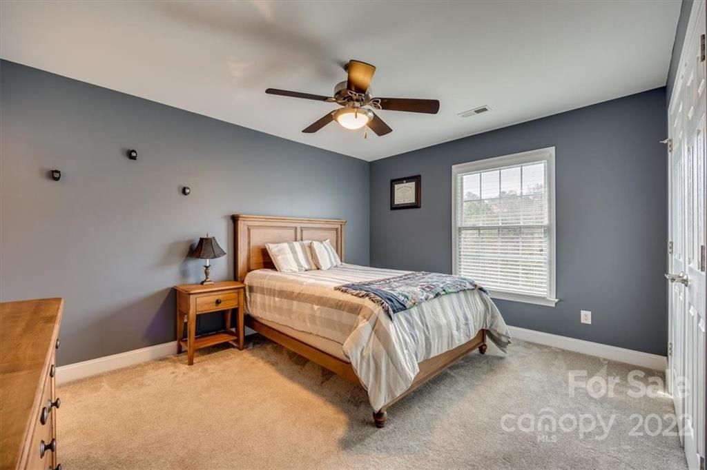 916 Cove Point Lane Tega Cay, SC 29708 - Photo 27 of 48 a bedroom with a bed gym equipment and a window