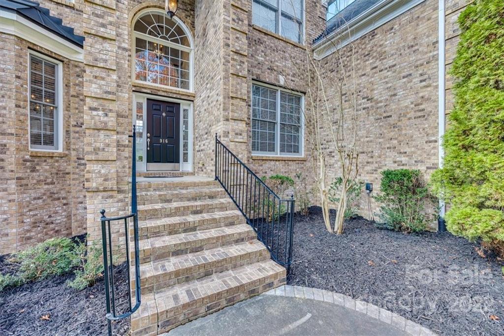 916 Cove Point Lane Tega Cay, SC 29708 - Photo 3 of 48 a view of a brick house with a yard