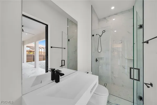 a bathroom with a tub sink shower and mirror