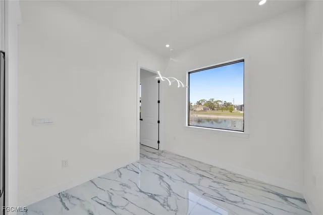 a view of a hallway with wooden floor and closet