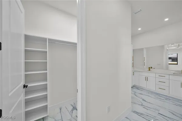 a room with white cabinets and a stove
