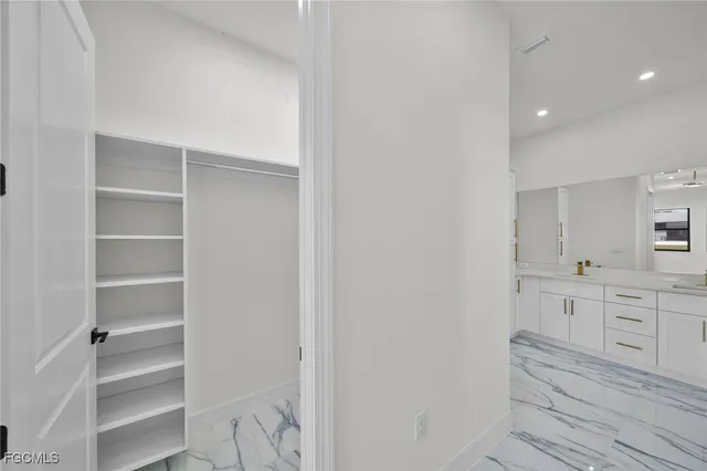a room with white cabinets and a stove
