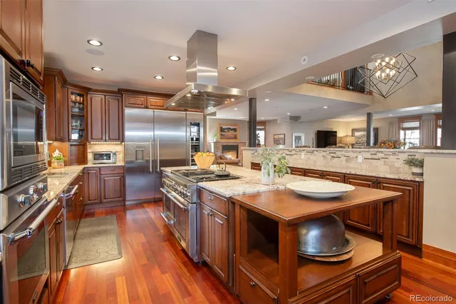 a kitchen with stainless steel appliances granite countertop a stove and a refrigerator