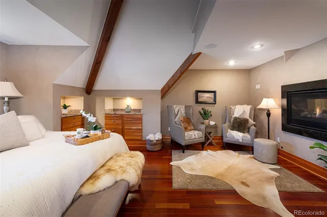 a bedroom with furniture and a flat screen tv