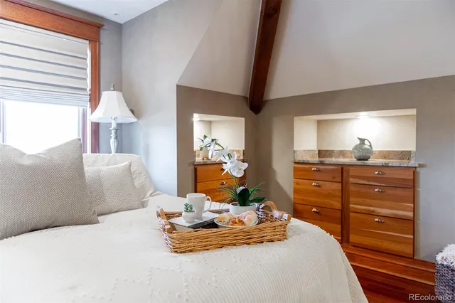 a bedroom with a bed and wooden floor