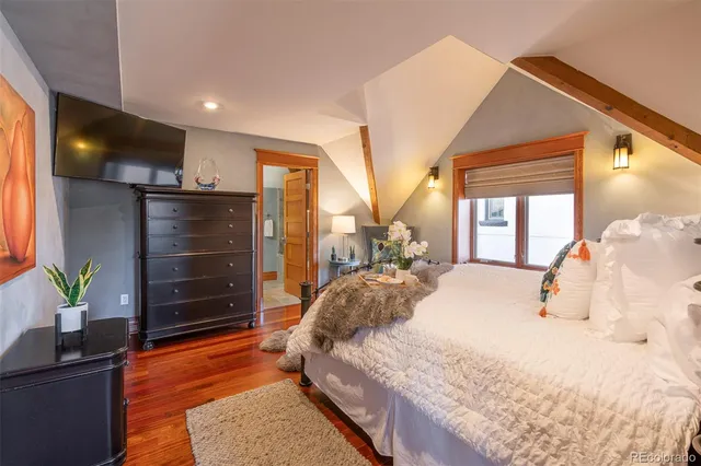 a bedroom with a bed and a potted plant