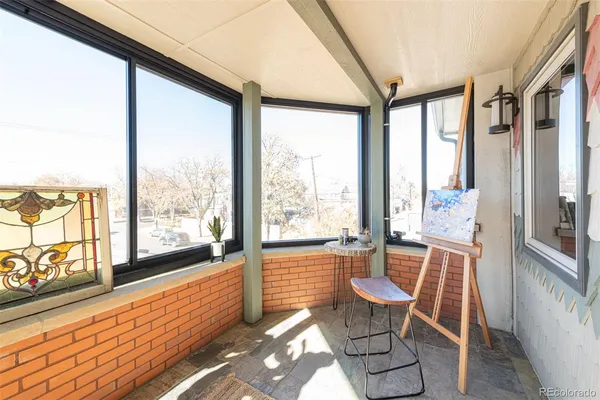 a view of a room with wooden floor and large windows