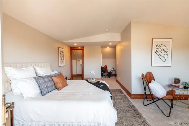 a bedroom with bed and a chair