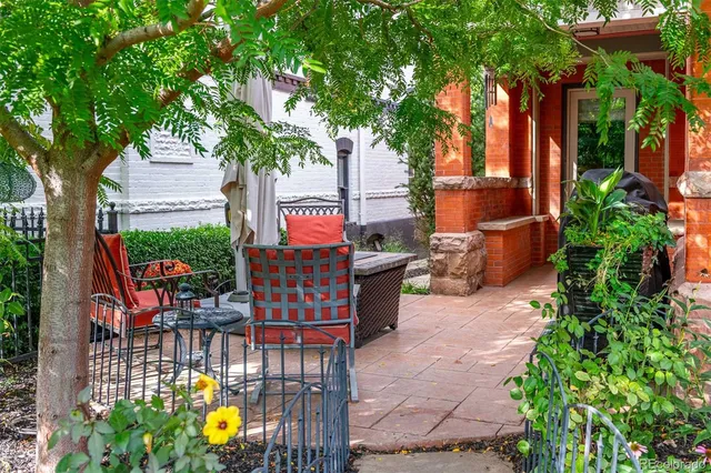 a view of an outdoor sitting area with brick walls