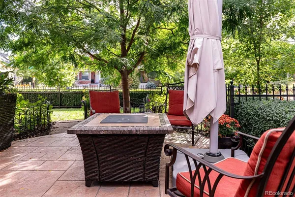a view of a patio with table and chairs potted plants with large tree