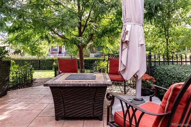 a view of a patio with table and chairs potted plants with large tree