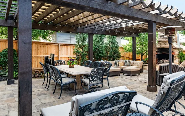 a outdoor space with patio couch and a fireplace