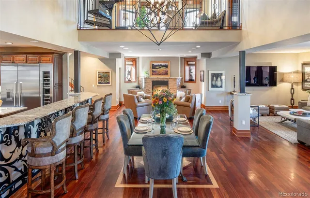 a view of a dining room with furniture a chandelier and wooden floor