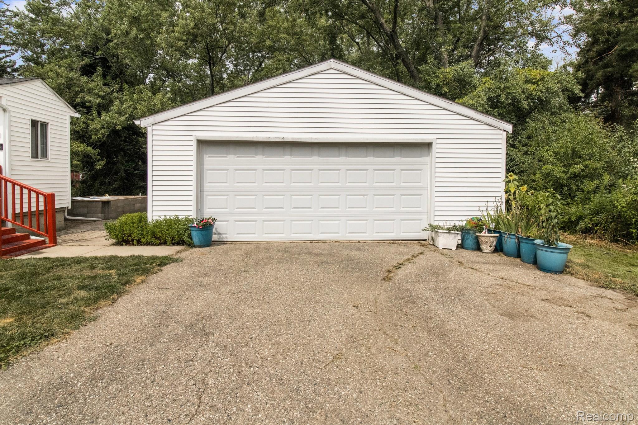7330 Embury Road Grand Blanc, MI 48439 - Photo 5 of 29 Detached garage with white horizontal siding and a white panel garage door